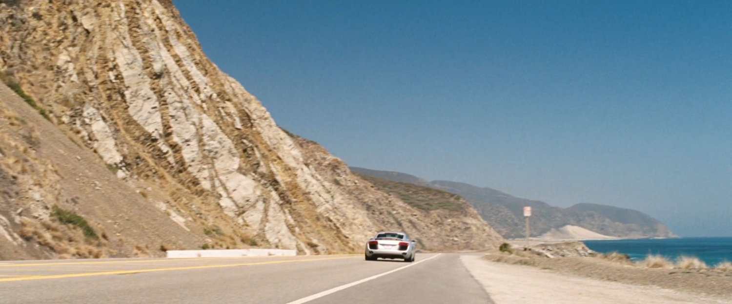 A silver Audi on a coastal road in Malibu.