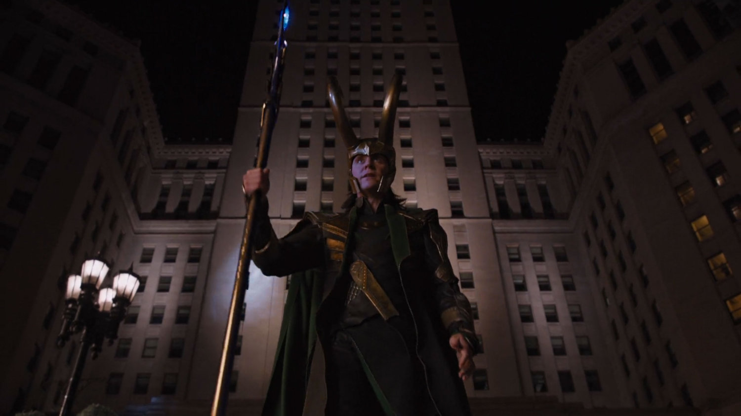 Loki stands out a tall building at night.