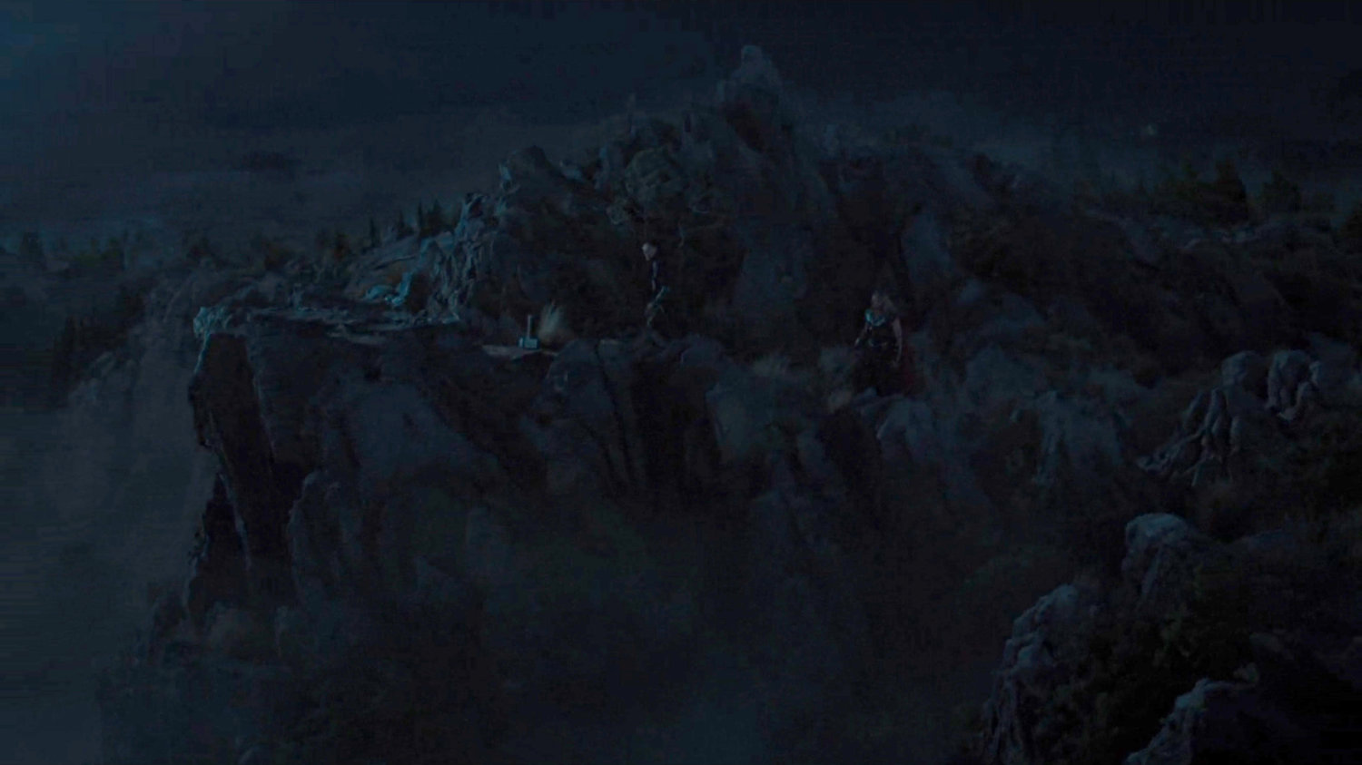 Loki and Thor on a dark mountain top.
