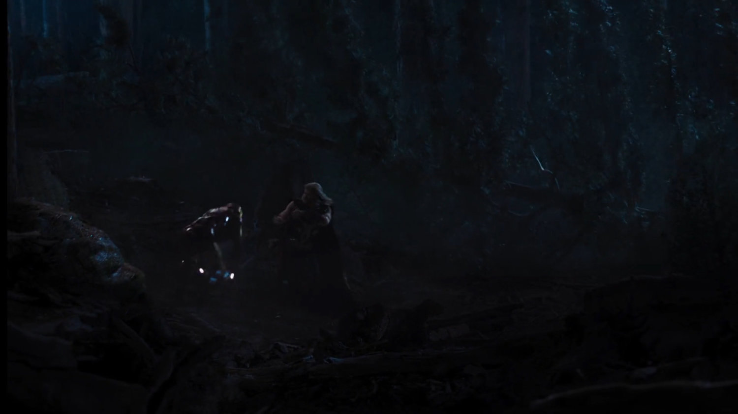 Iron Man and Thor fight in a dark forest.