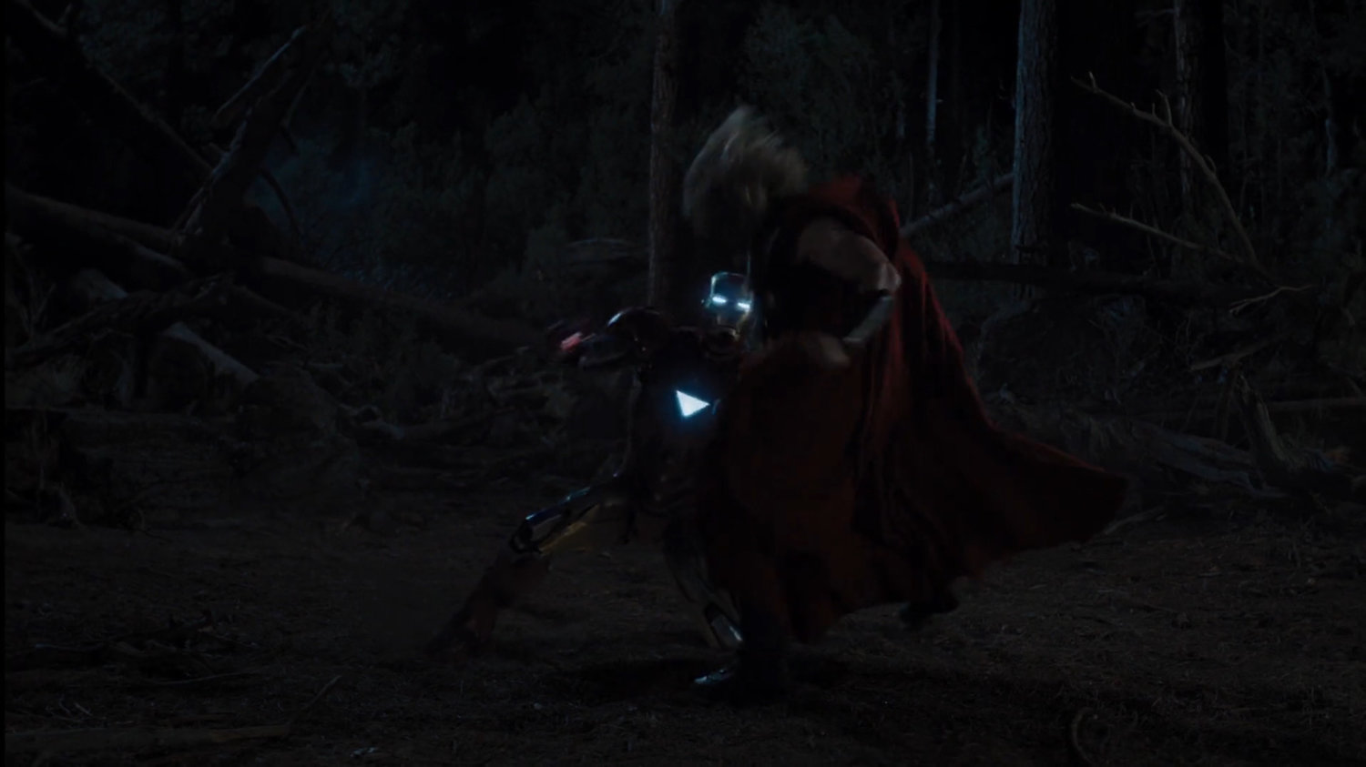 Iron Man and Thor fight in a dark forest.
