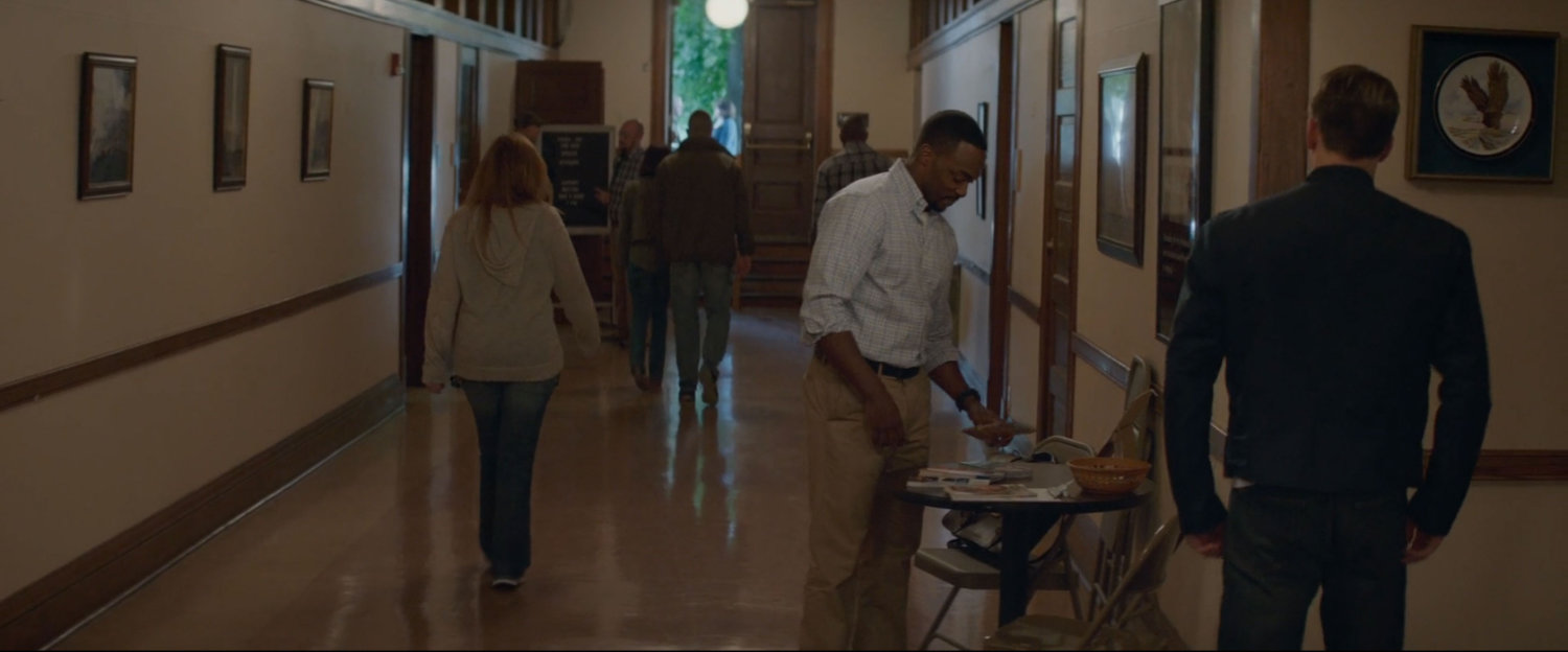 Sam Wilson cleans up a small table in a hallway of the Veterans Affairs office.