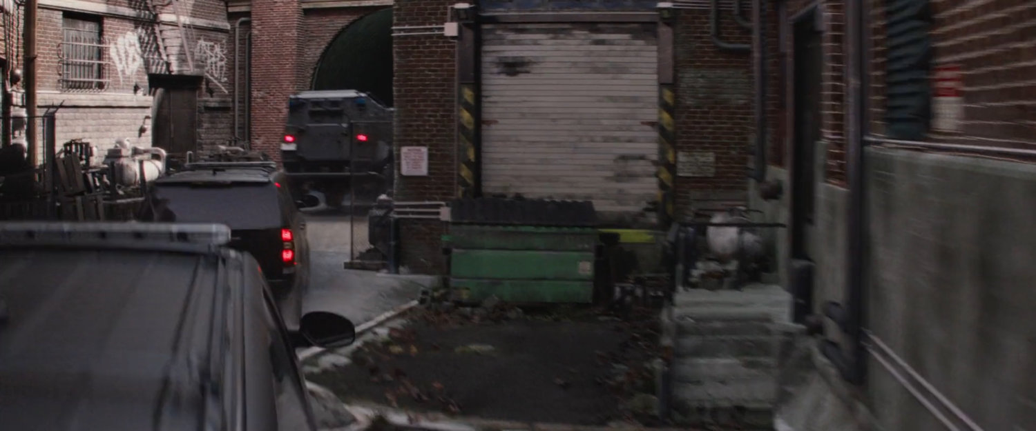 STRIKE vehicles entering a dilapidated warehouse.