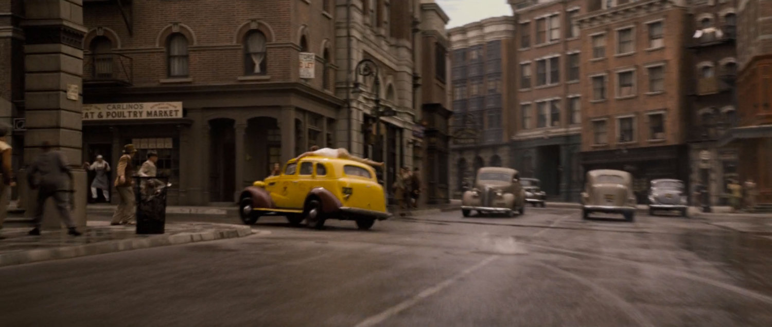 Yellow Cab turns a corner off a 1942 New York street.