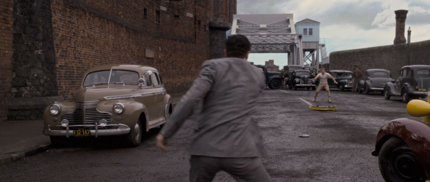 A German saboteur fires a gun at Steve Rogers at Pier 13.