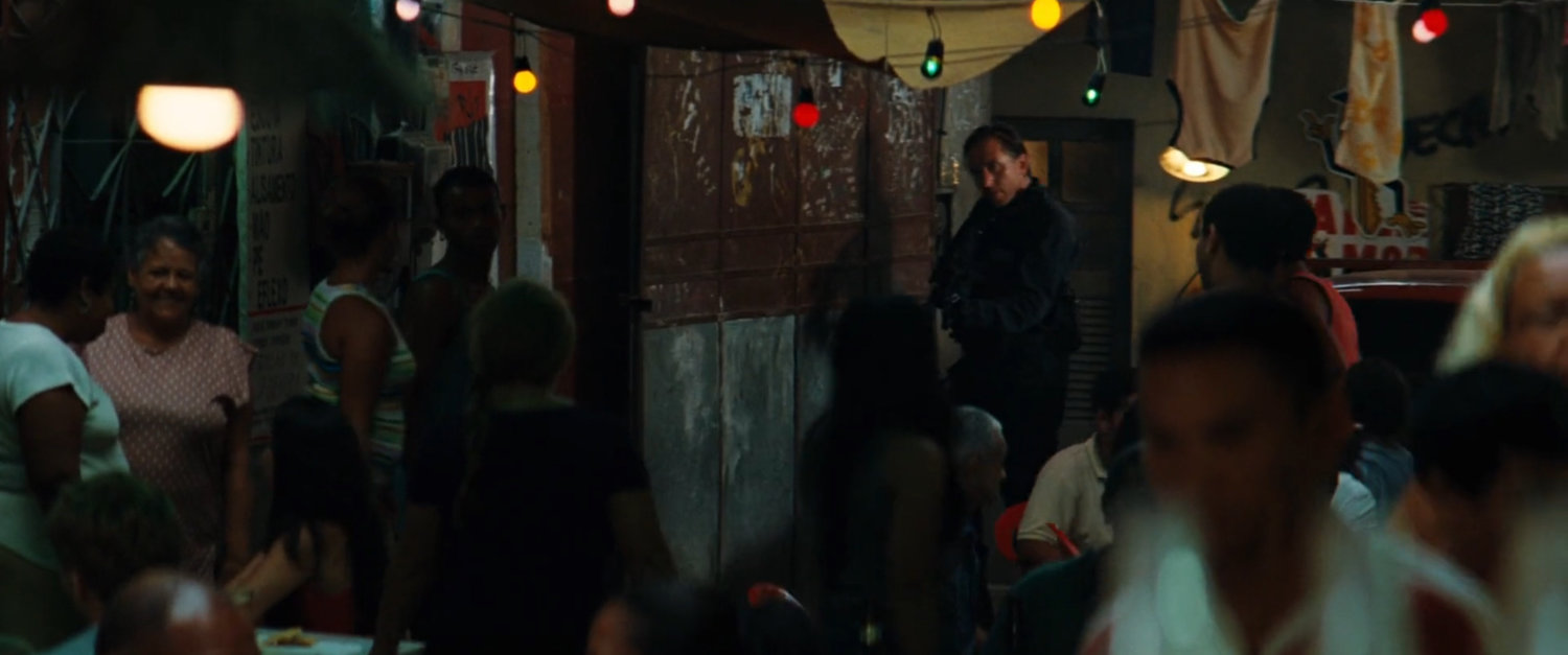 Emil Blonsky approaches a favela cafe.