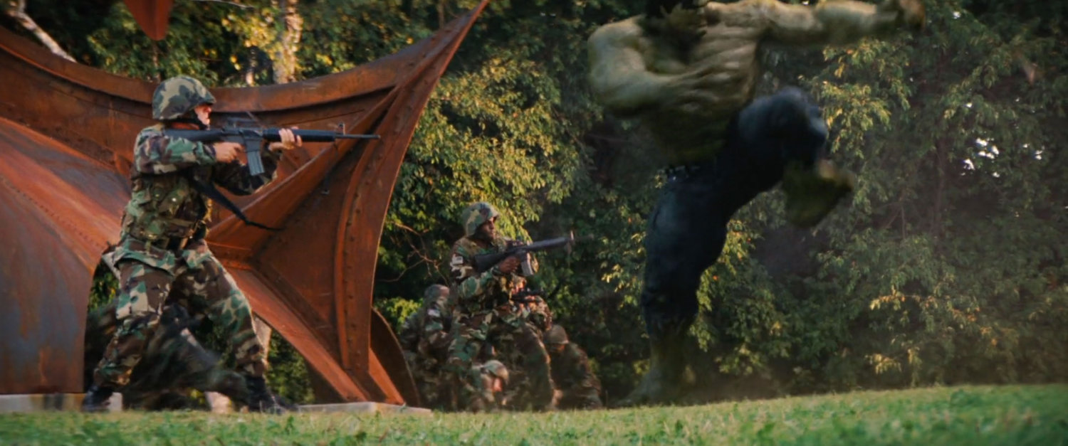 Hulk fighting soldiers in a park.