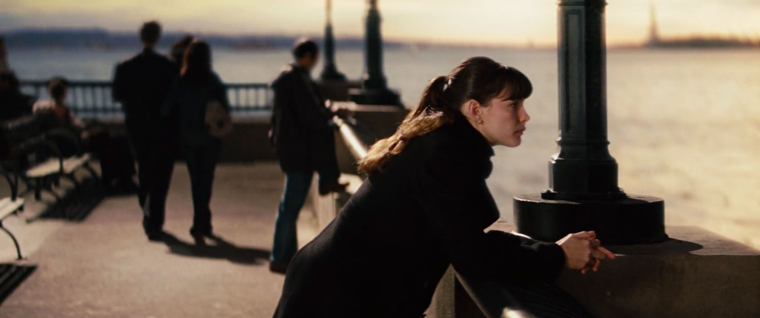 Betty Ross leaning on a railing near the water.