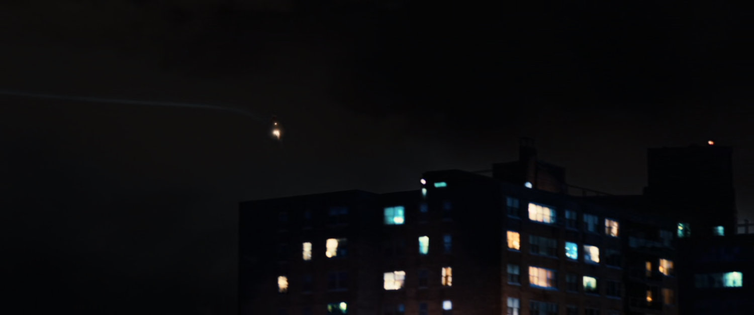 Nighttime shot of apartment complex.