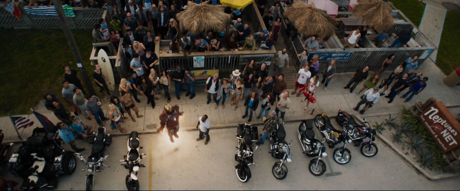 Iron Man blasts off outside Neptune's Net restaurant, surrounded by onlookers..