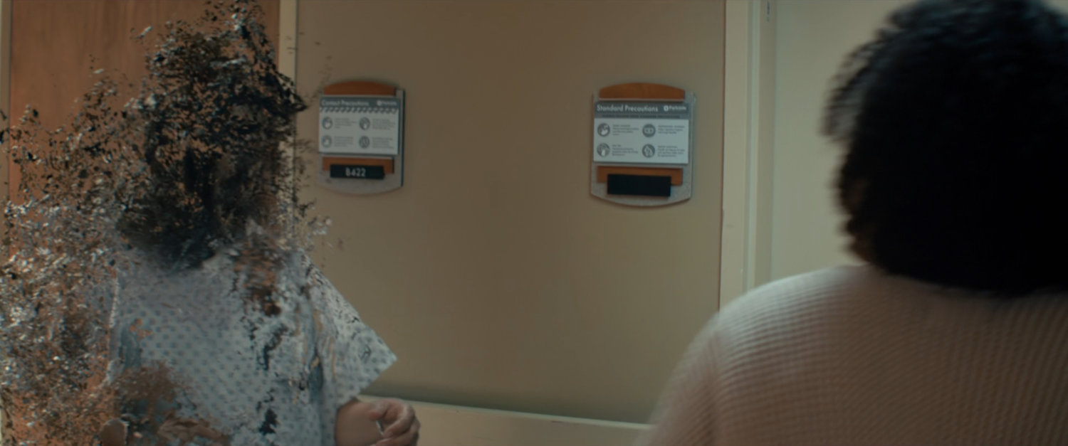 A woman returns from the Blip in a hospital corridor.