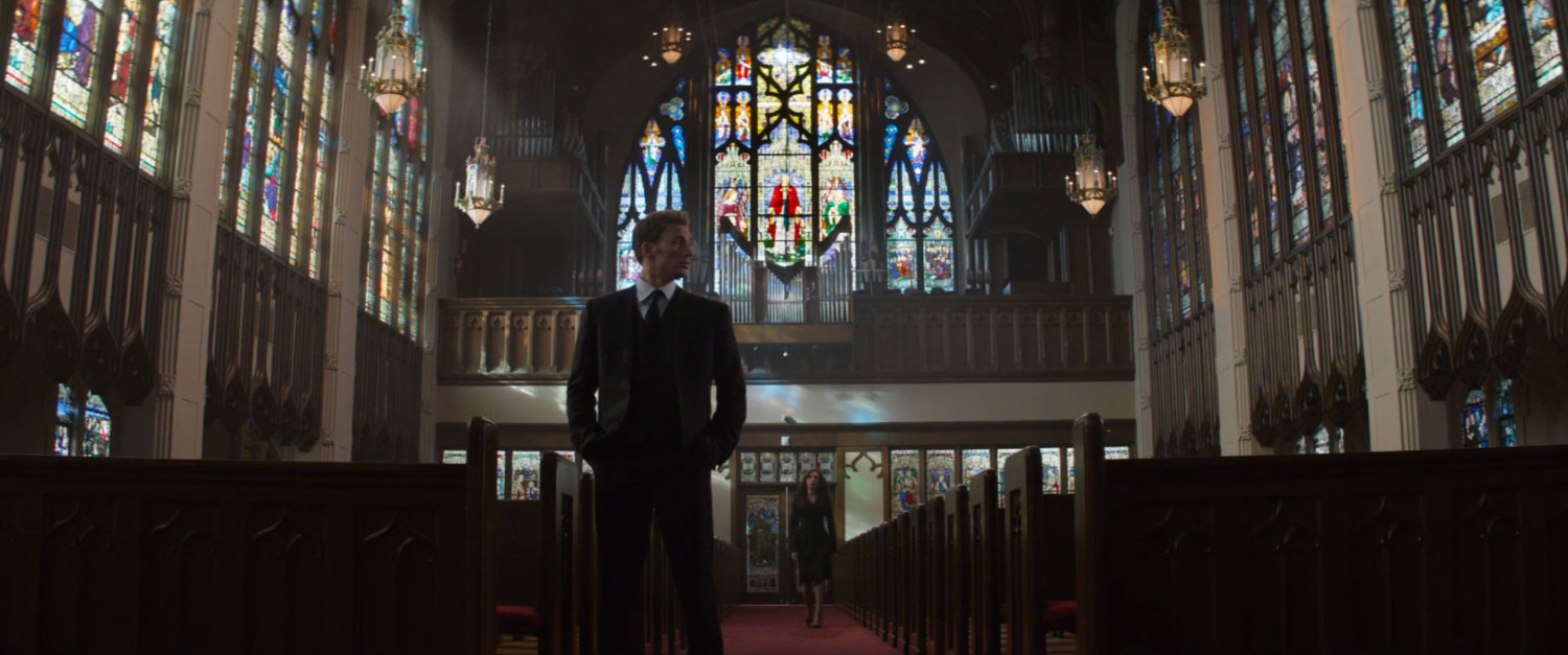 Steve Rogers in a London Church, with stained glass in the background.