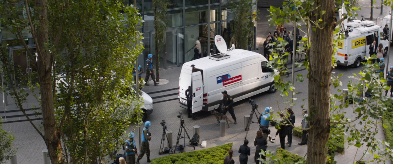 View of white TV vans from an window at the United Nations complex.
