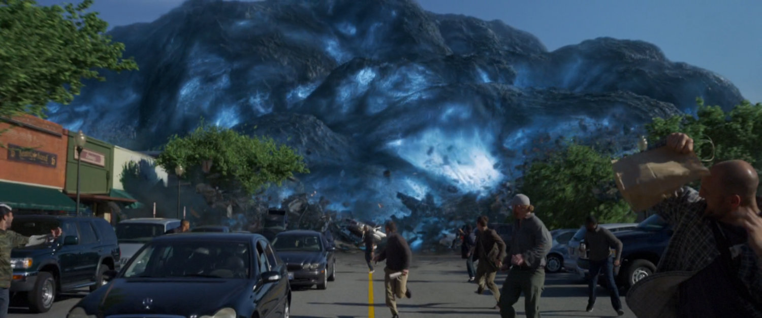 A giant alien spore chases people down a street.