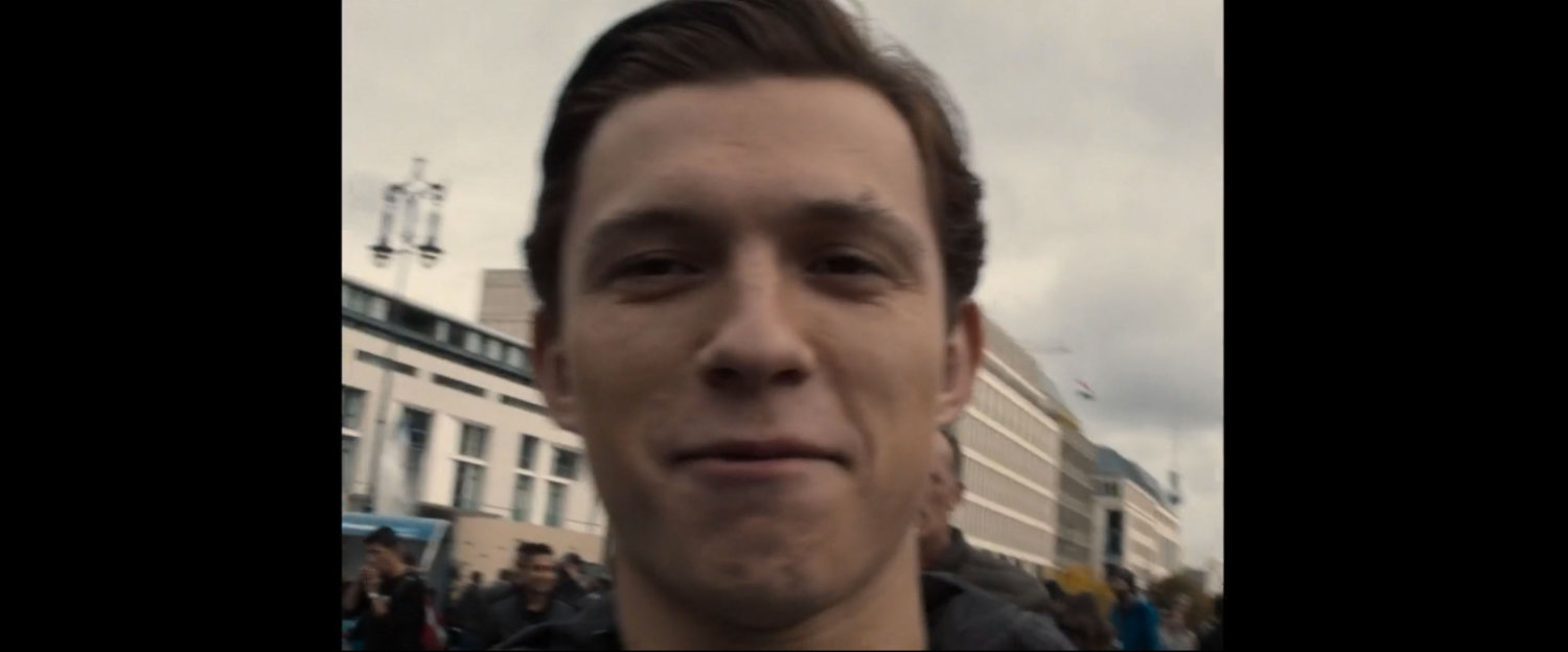 Selfie of Peter Parker in front of Brandenburg gate buildings.