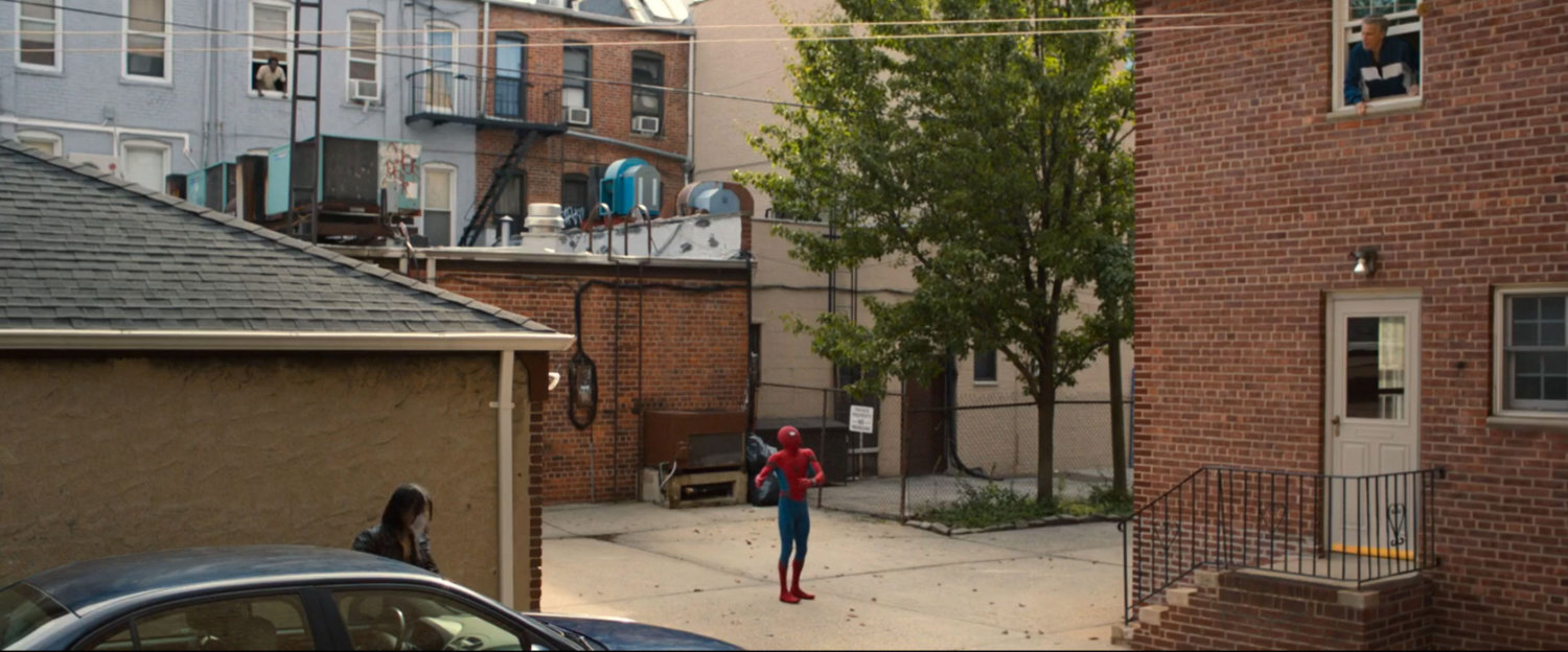 Spider-Man in parking area behind building arguing with neighbors in windows.