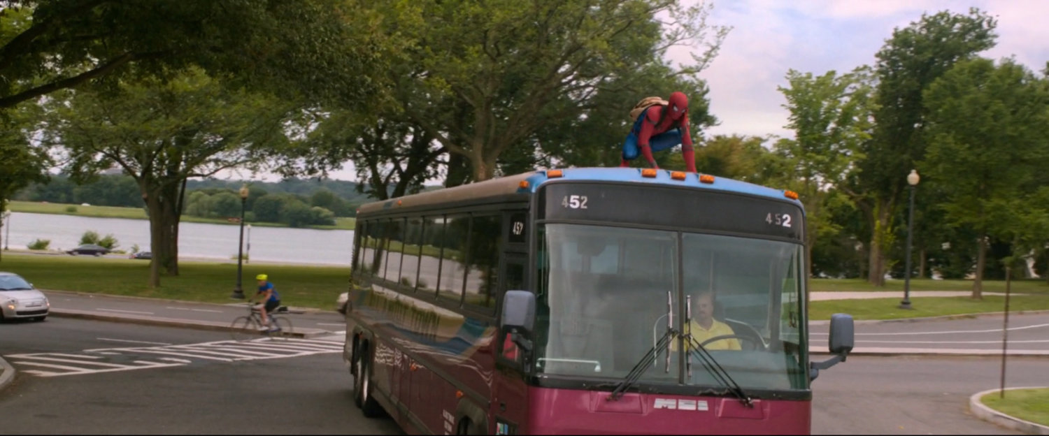 Spider-Man on top of tour bus.