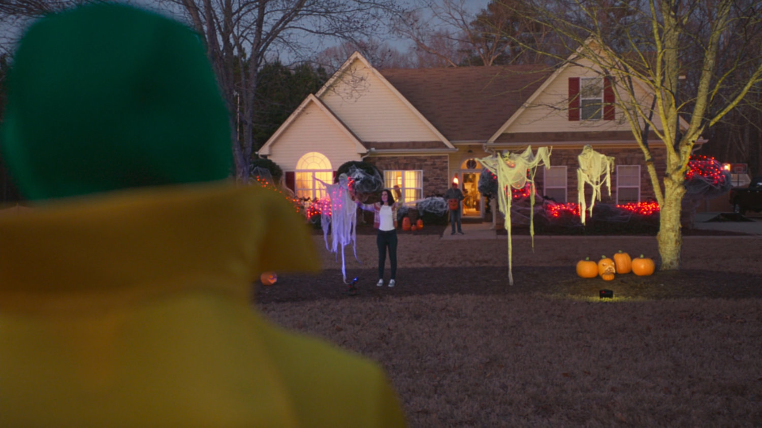 The Vision watching a family decorating their house for Halloween.