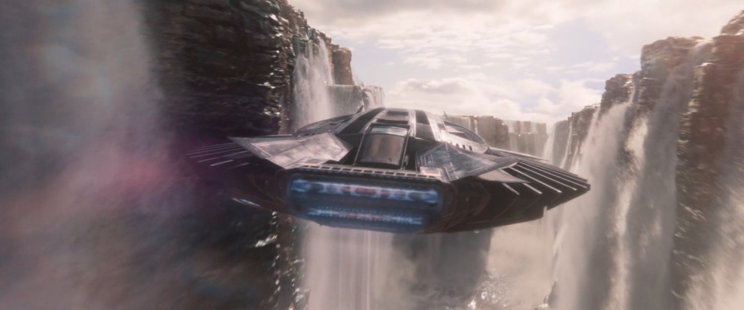 A Talon Fighter flies towards a waterfall.