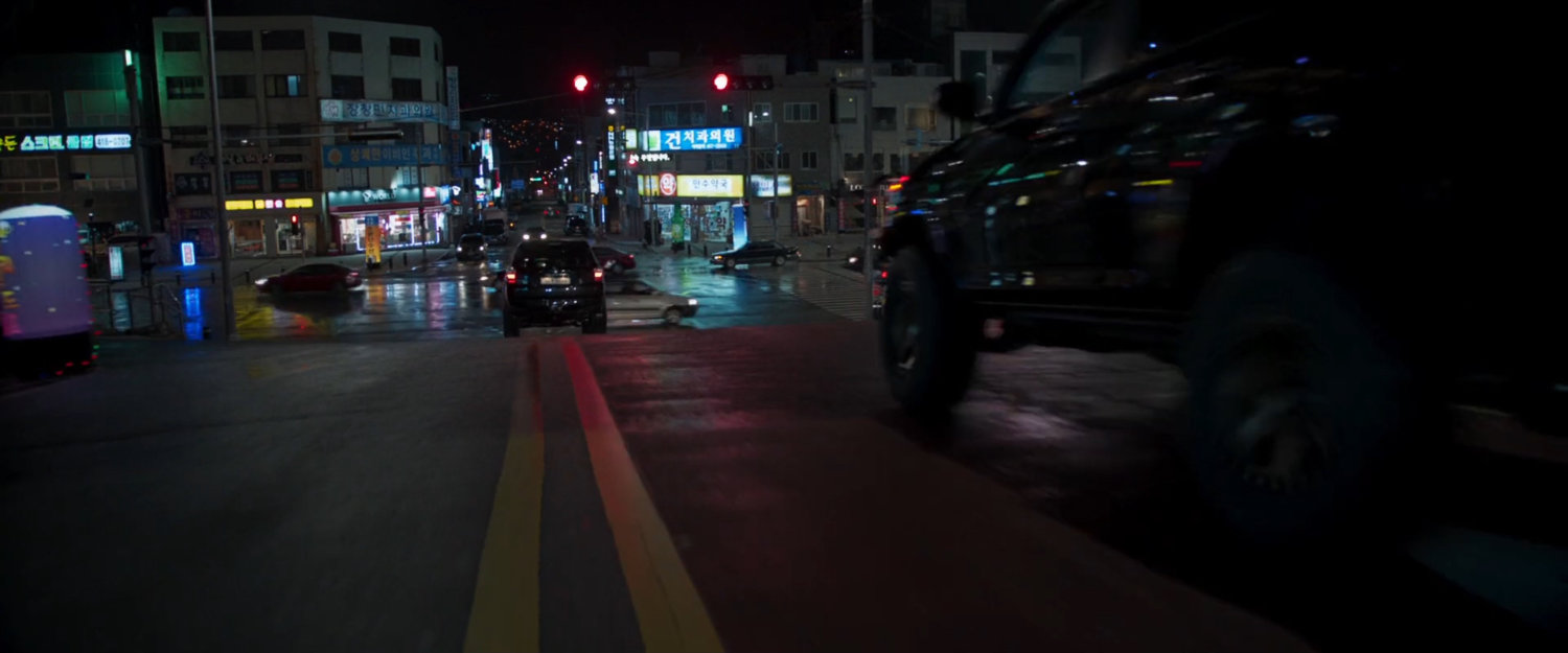 SUVs head towards busy Busan intersection.