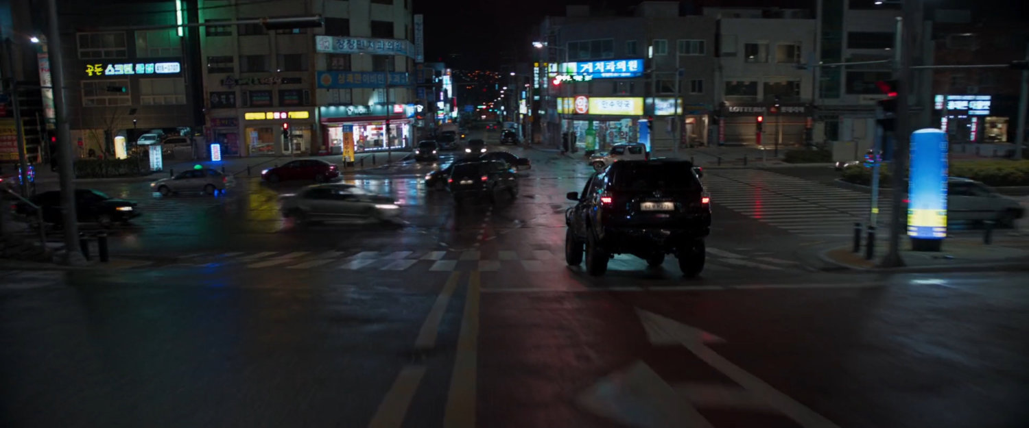 SUVs head towards busy Busan intersection.