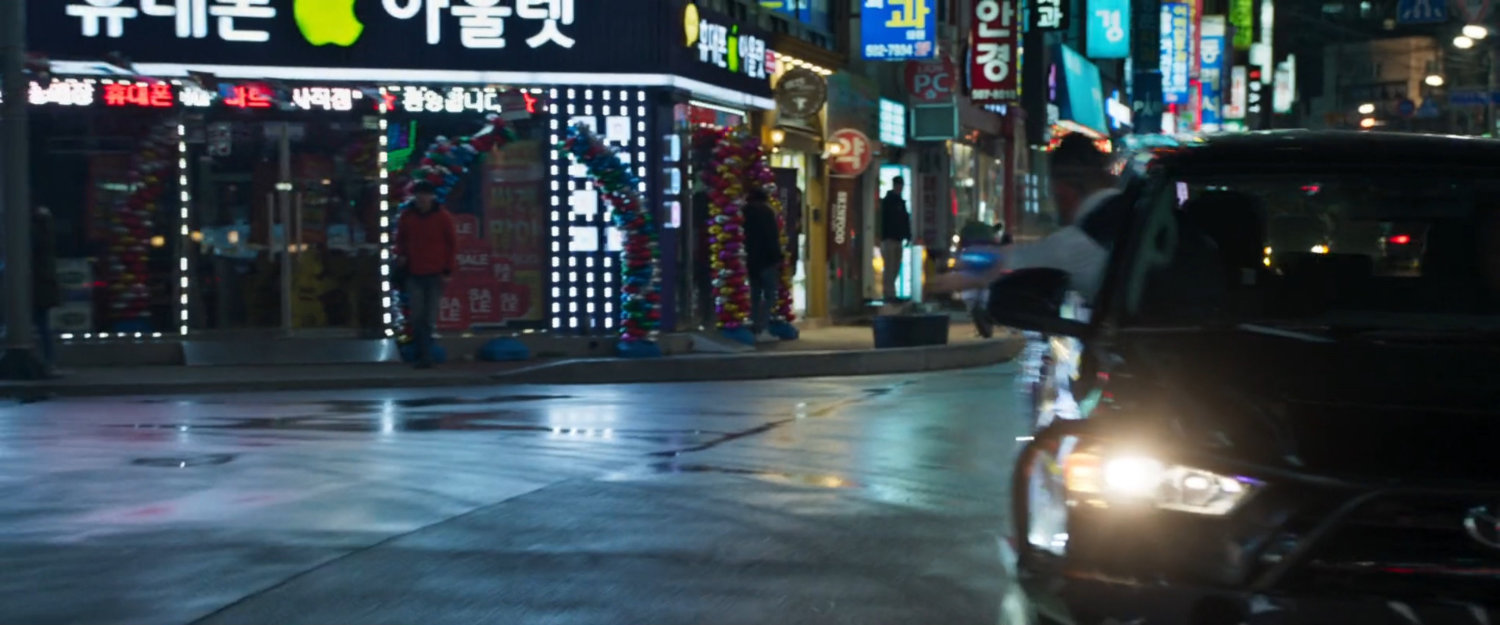 Klaue leaning out of SUV in Busan intersection.