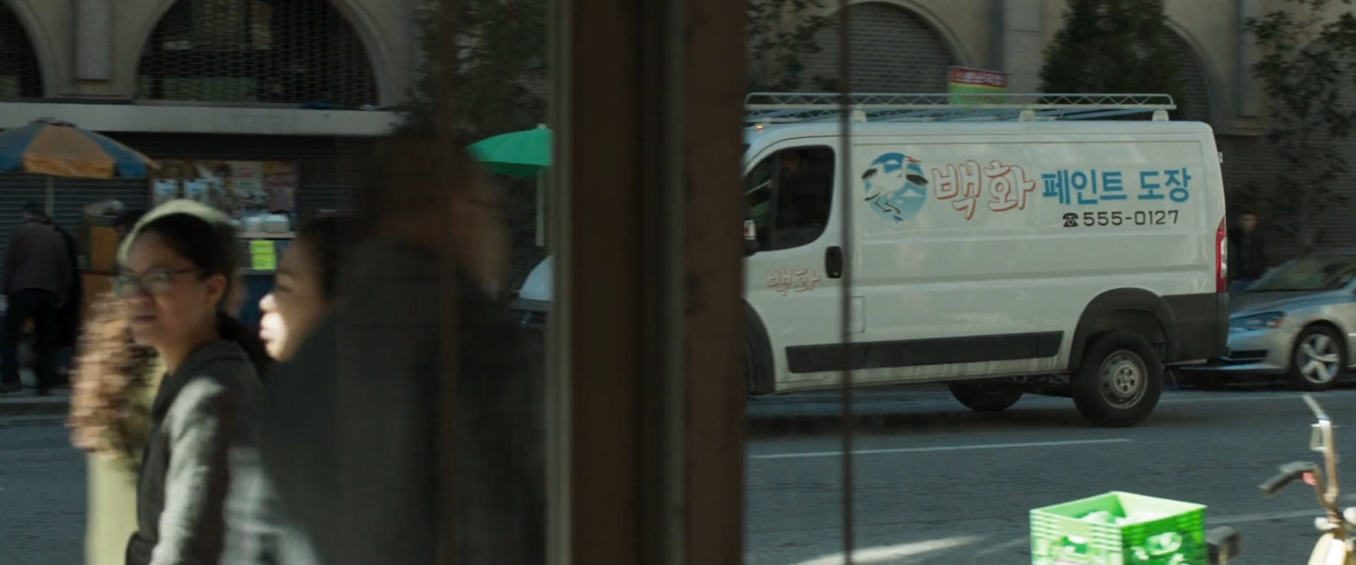 A white van cruises past a police station in Busan.