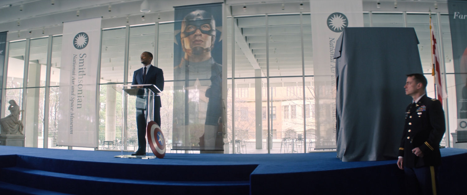 Sam Wilson on stage in front of an audience at the Smithsonian.