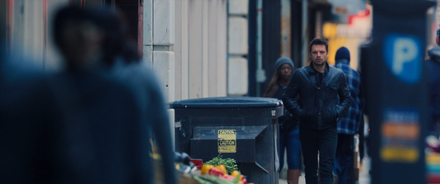 Bucky Barnes walking on a street in Brooklyn.