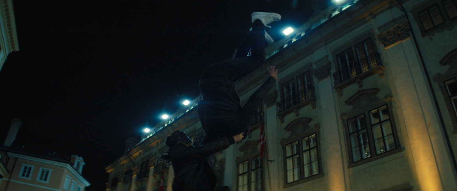 Man flipping another man outside the Gasel Bank in Switzerland.