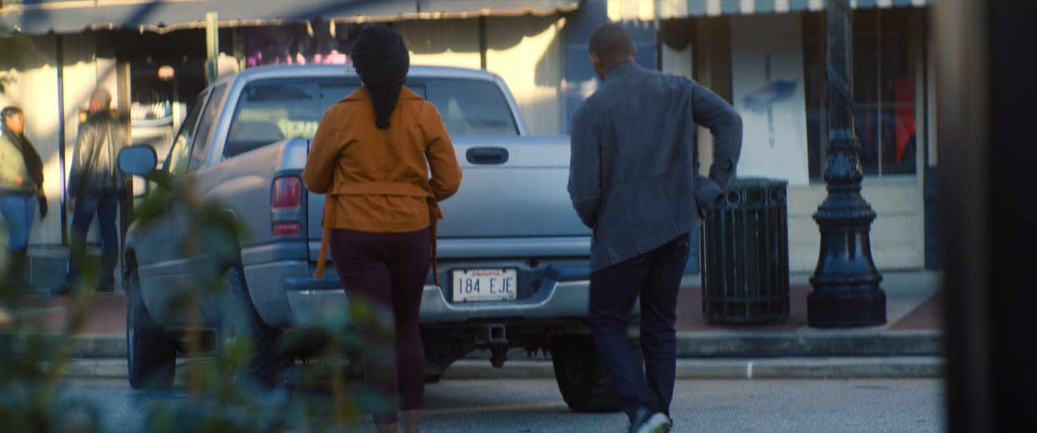 Sam and his sister walk to their car outside the bank.