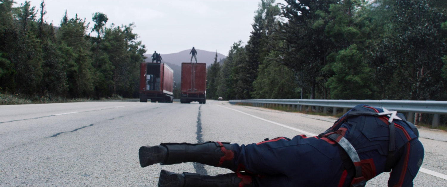 John Walker on German interstate watching two trucks drive away.