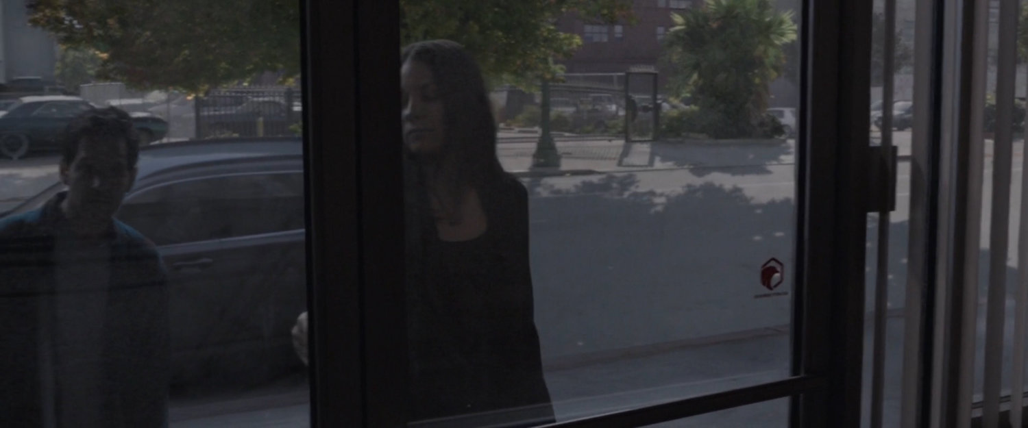 View from inside building as Hope unlocks door.