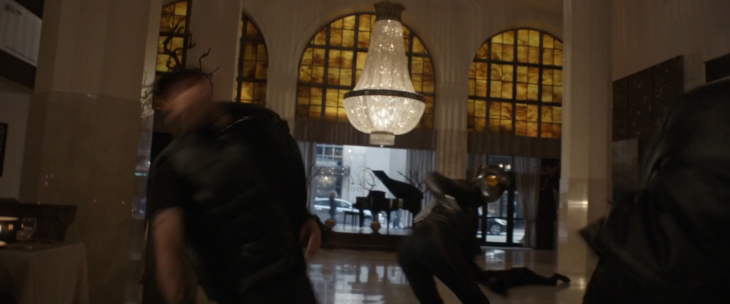 Hope fights thugs in giant space, with massive chandelier.