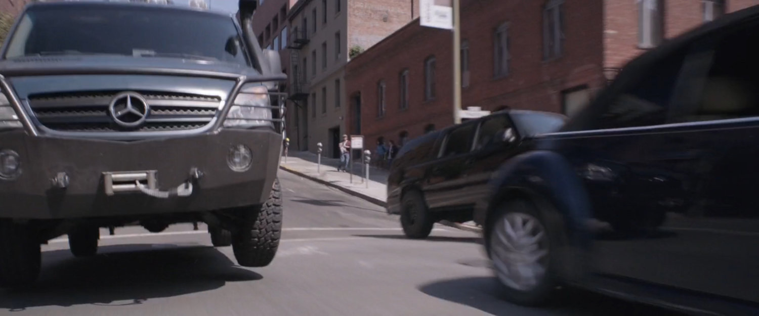 SUV chasing van on San Francisco street.