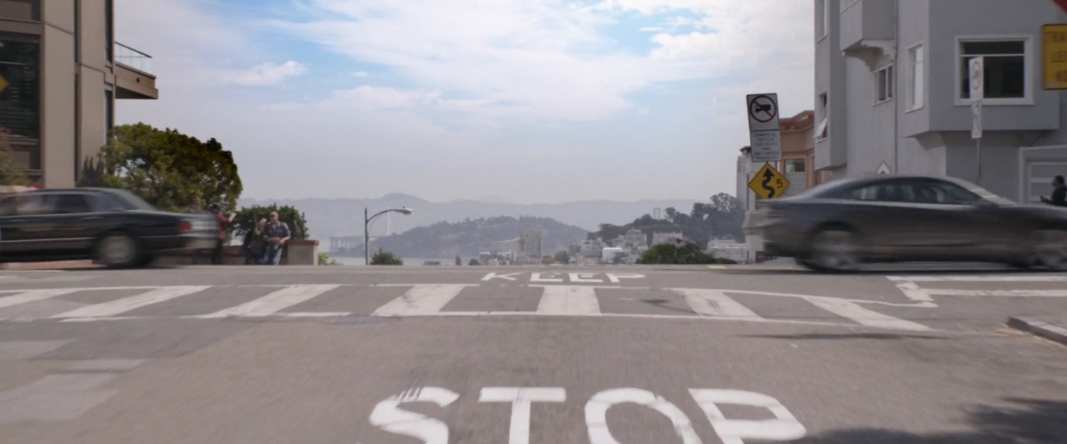 POV of van driving through intersection onto Lombard Street.