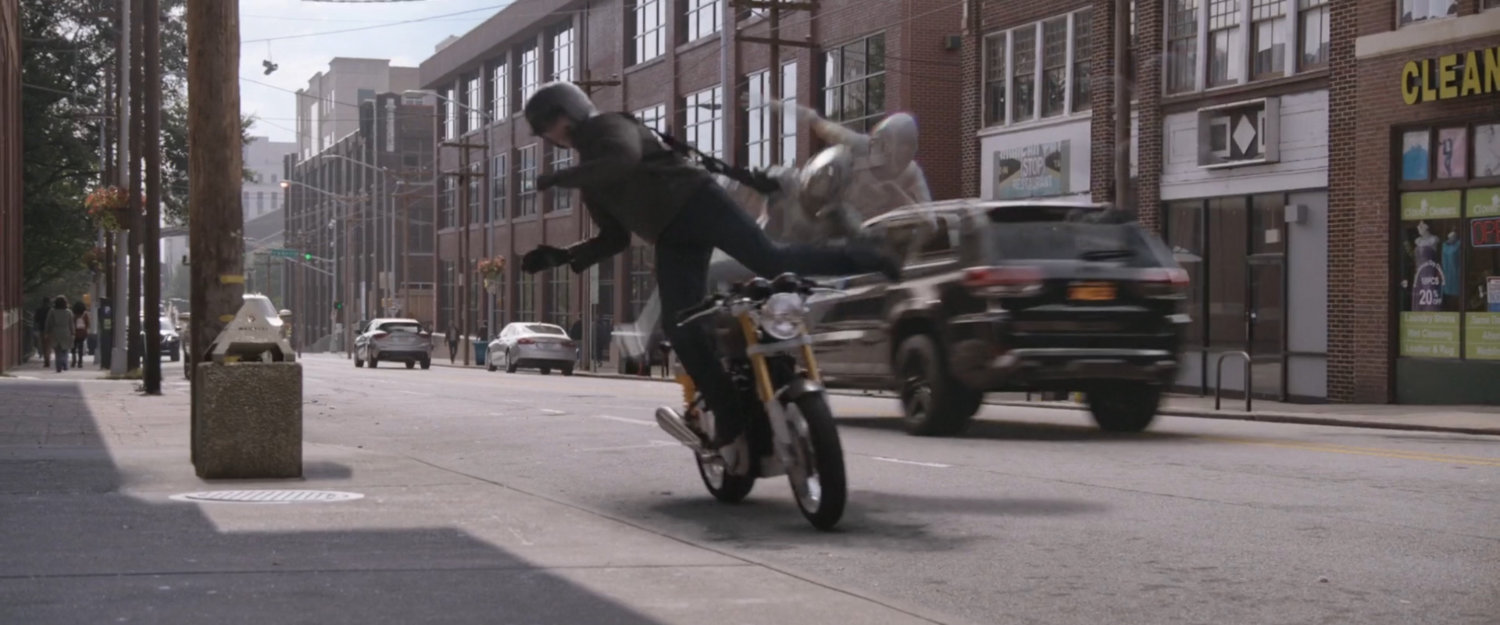 The Ghost knocks a motorcycle rider of his bike.