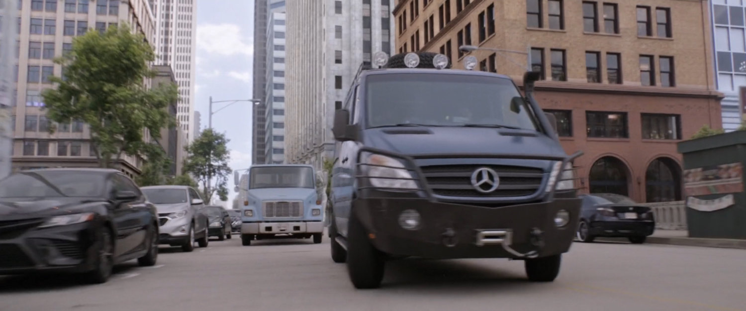 Flatbed truck chasing the van.