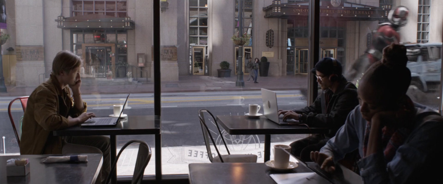 Coffee house patrons ignoring Giant-Man outside the window.