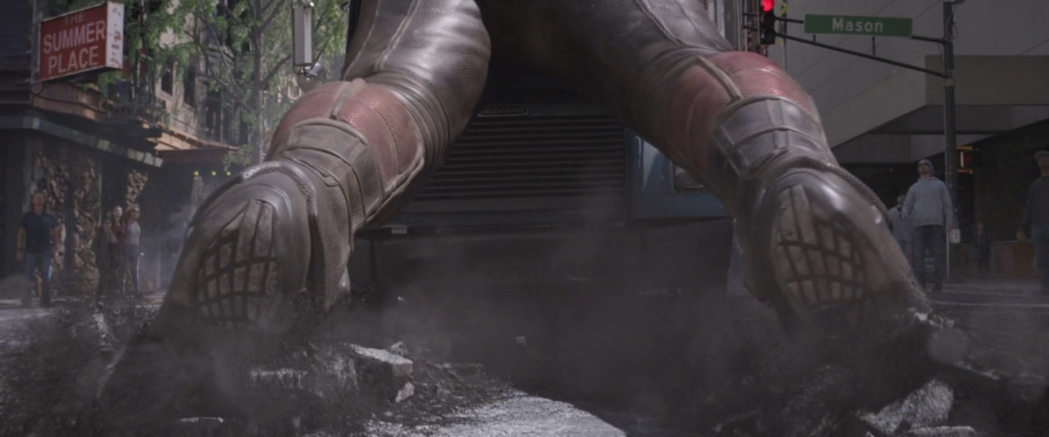 Close-up of Giant-Man legs as he stops runaway flatbed truck.