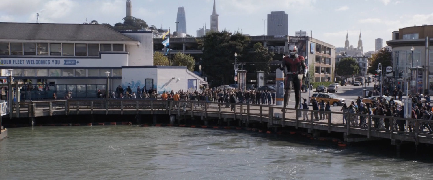 Giant-Man stands by the dock on the Embarcadero.