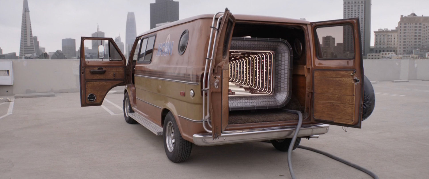 The quantum tunnel van parked on a parking garage roof.