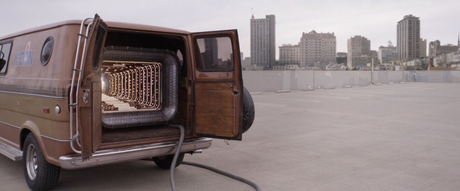 The quantum tunnel van parked on a parking garage roof.