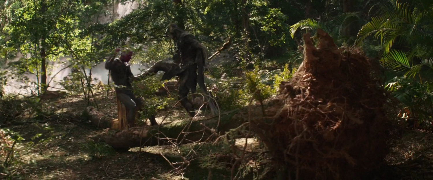 Vision and Corvus Glaive fight in a forest.