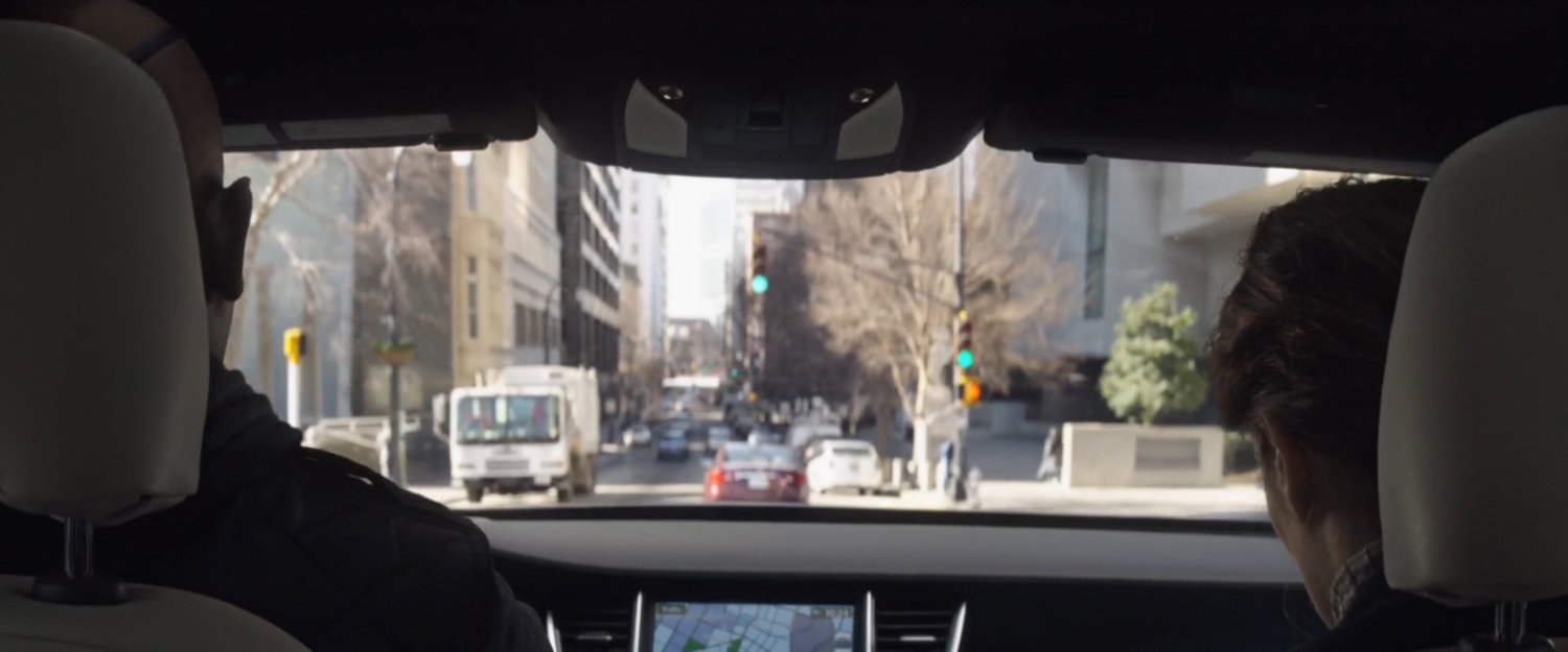 View of city street from inside car.
