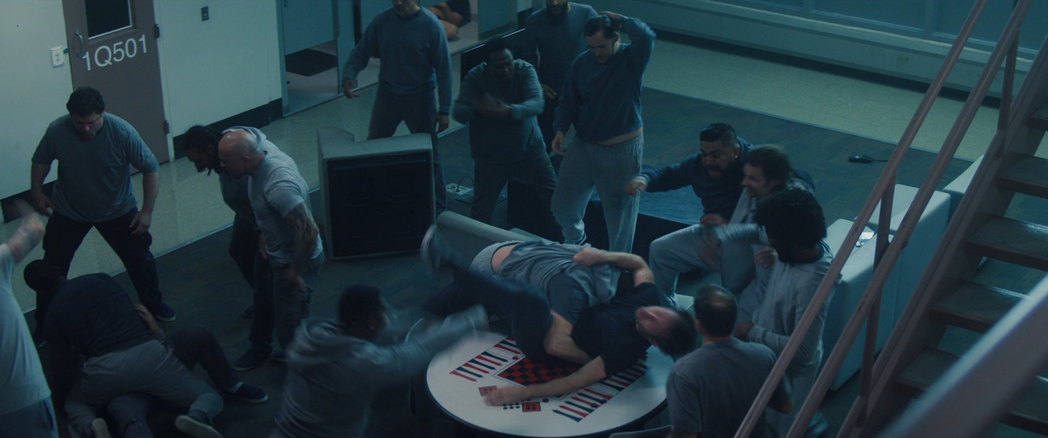 Prisoners fighting in a common room.