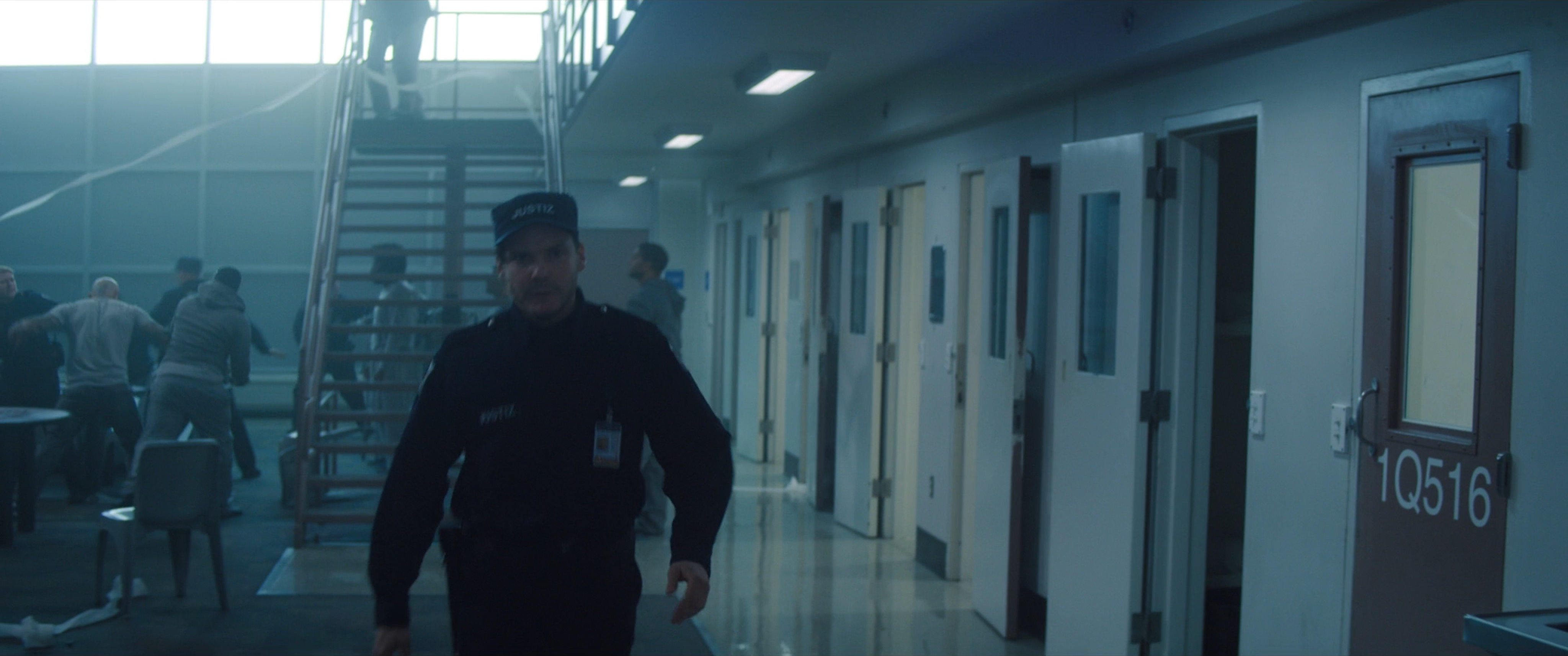 Zemo disguised as a guard in a prison hallway.