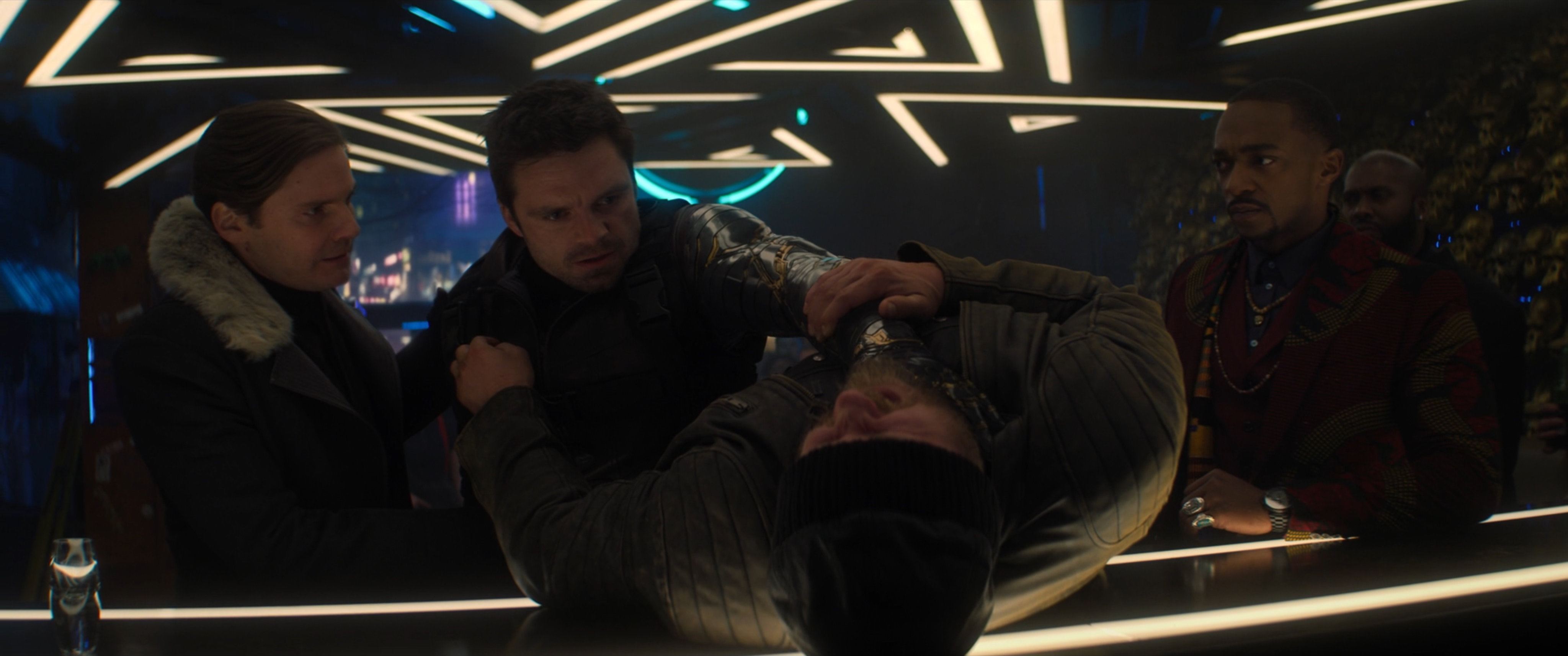 Zemo, Bucky, and Sam inside of the Brass Monkey bar.