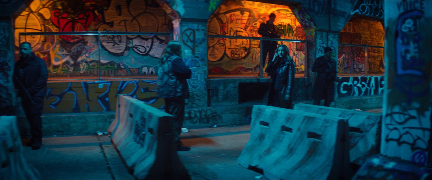 Sharon walking through a graffiti painted tunnel in Madripoor.