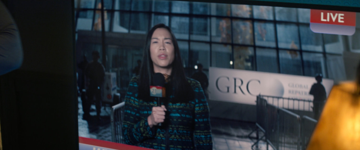 A WHIH news reporter outside the GRC Council building.